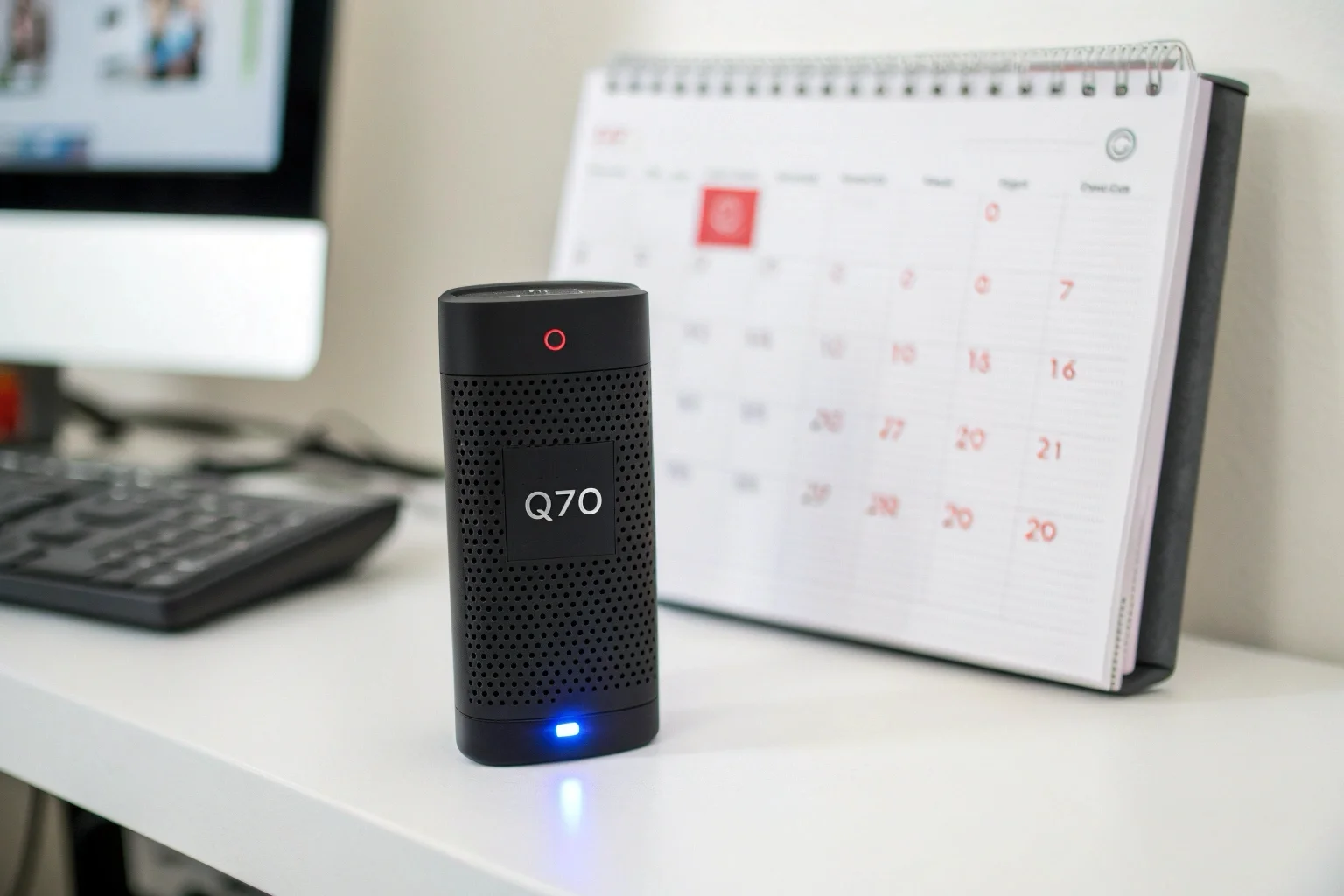 The Q70 voice recorder next to a calendar showing 21 days crossed off, highlighting its long battery life.