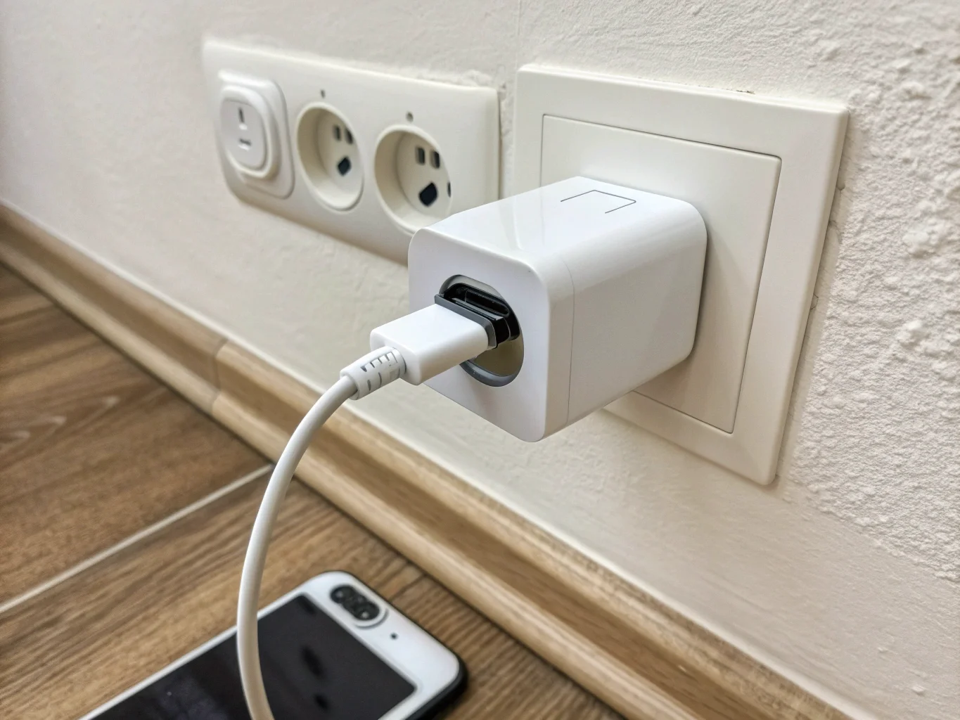 A hidden camera disguised as a USB charger plugged into a wall socket