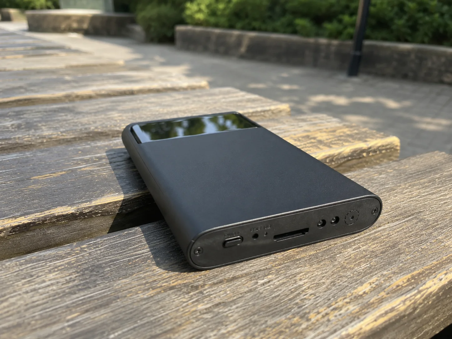 QZT H3 power bank hidden camera used on a desk with phone and personal items