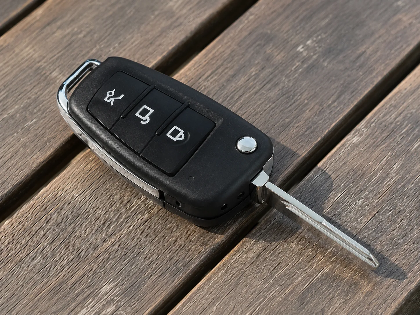 QZT S820 car key spy camera placed on a wooden table