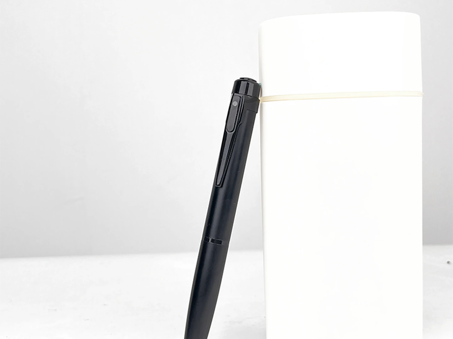 QZT W10 spy pen camera on notebook in office scene