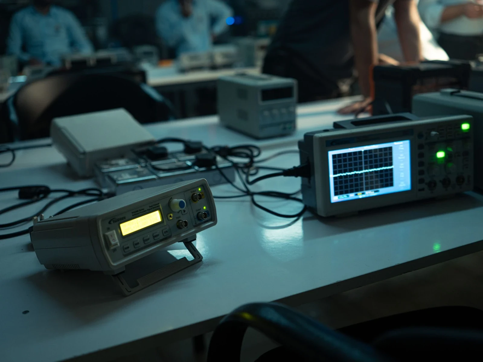 Oscilloscope and test instruments on a lab bench
