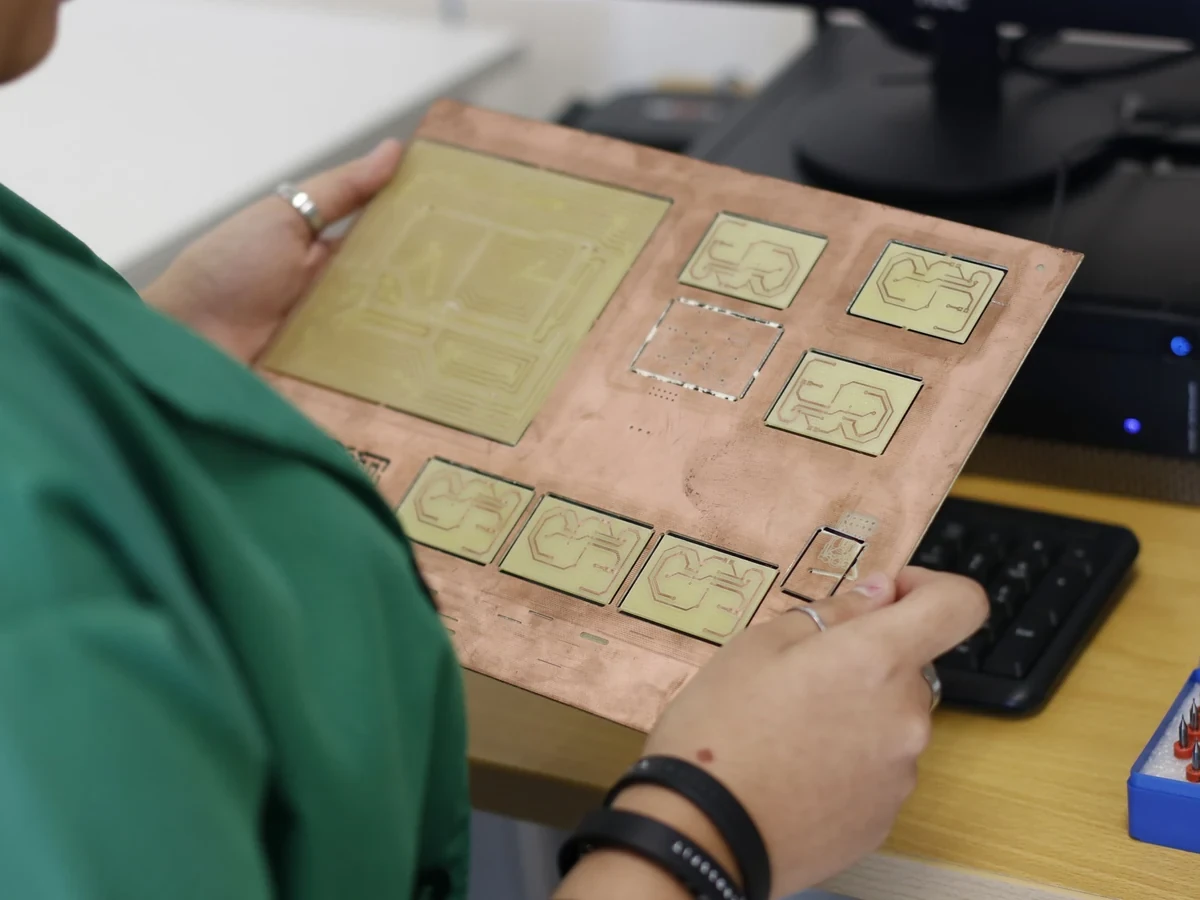 Electronics technician handling a PCB