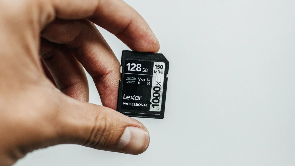 Memory card selection for continuous camera recording Person holding a 128GB memory card for continuous camera recording