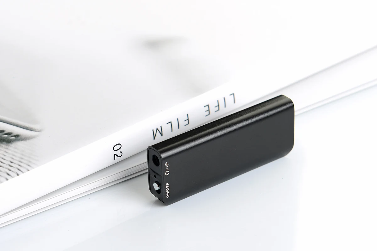 Q23 black recorder resting beside a notebook