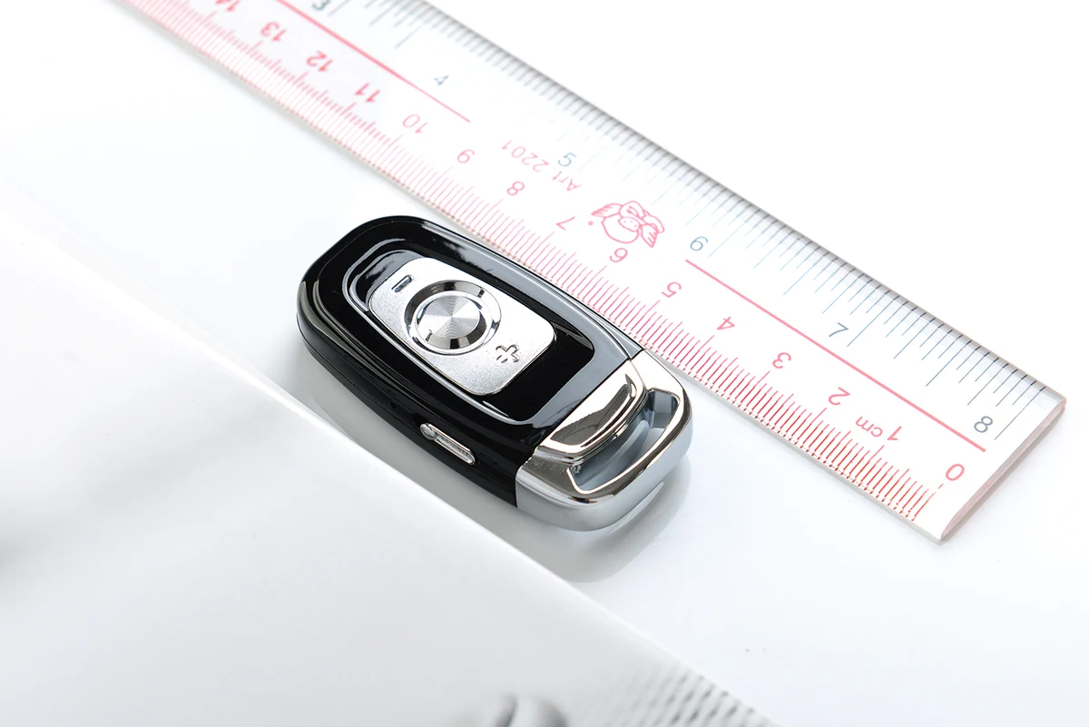 Q5 keyring voice recorder beside a centimeter ruler