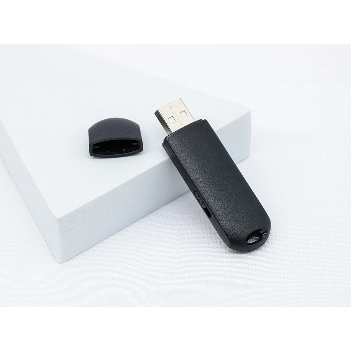Q62 black USB voice recorder with cap removed, real product photograph
