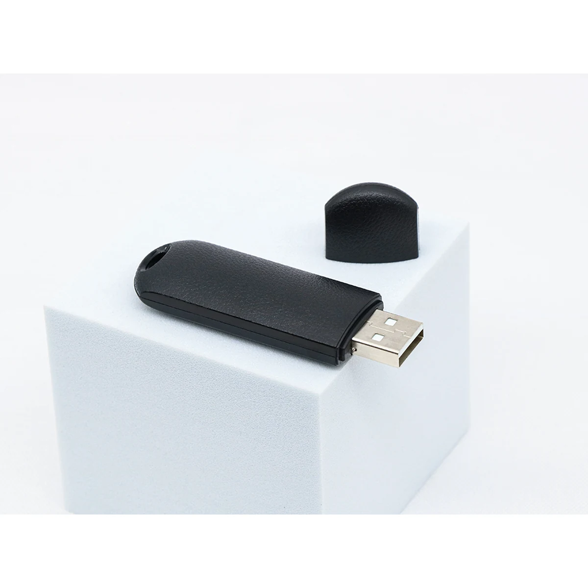 Q62 voice recorder on a white display block with USB plug exposed