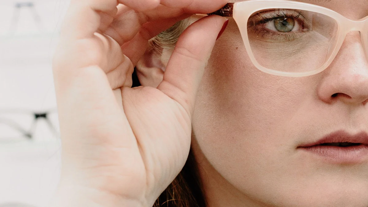 Customer trying on eyeglasses in an optical store for frame-fit evaluation