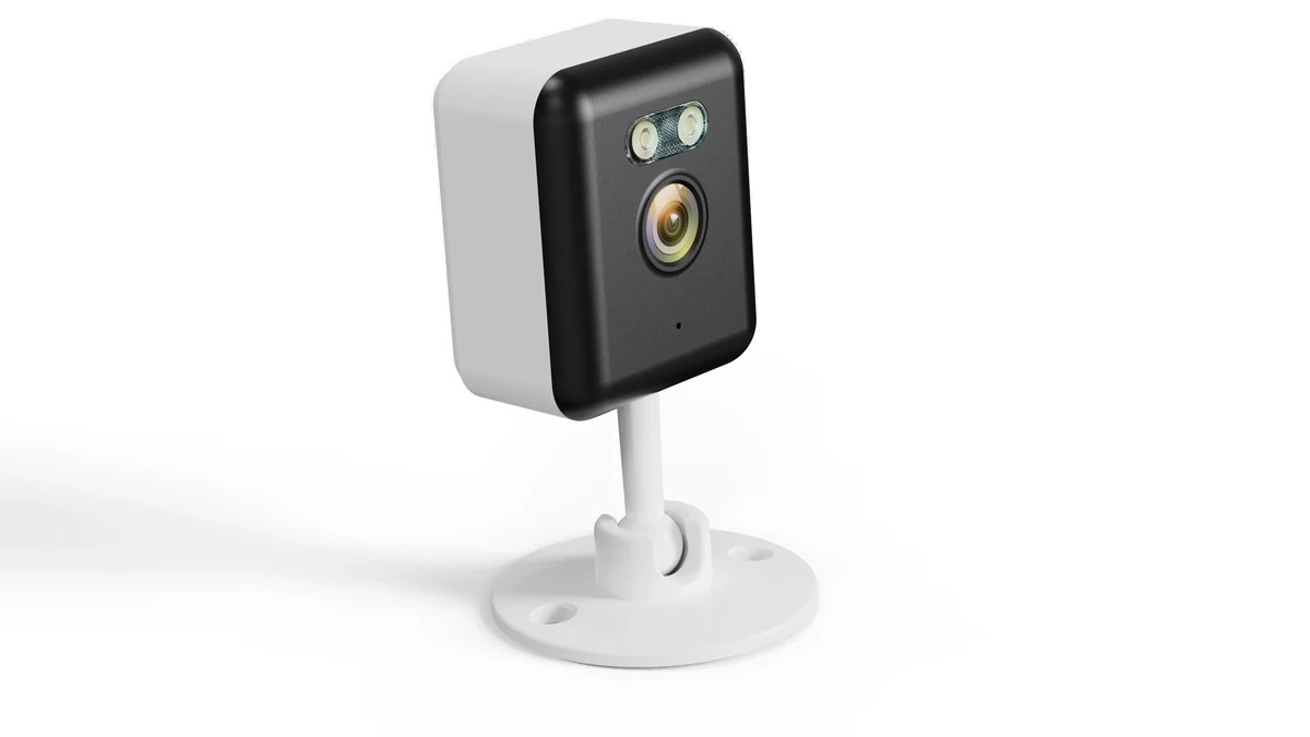 QZT C12 telecamera WiFi da interno visibile in una scena di prodotto attuale