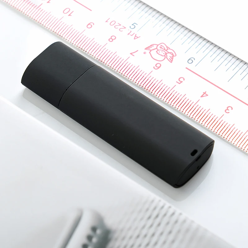 X10 USB voice recorder beside a centimeter ruler