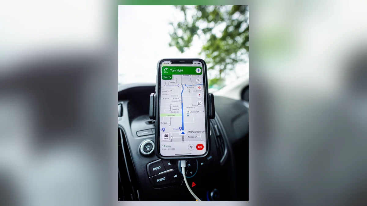 Smartphone displaying a navigation map in a vehicle, illustrating how a virtual boundary can be checked