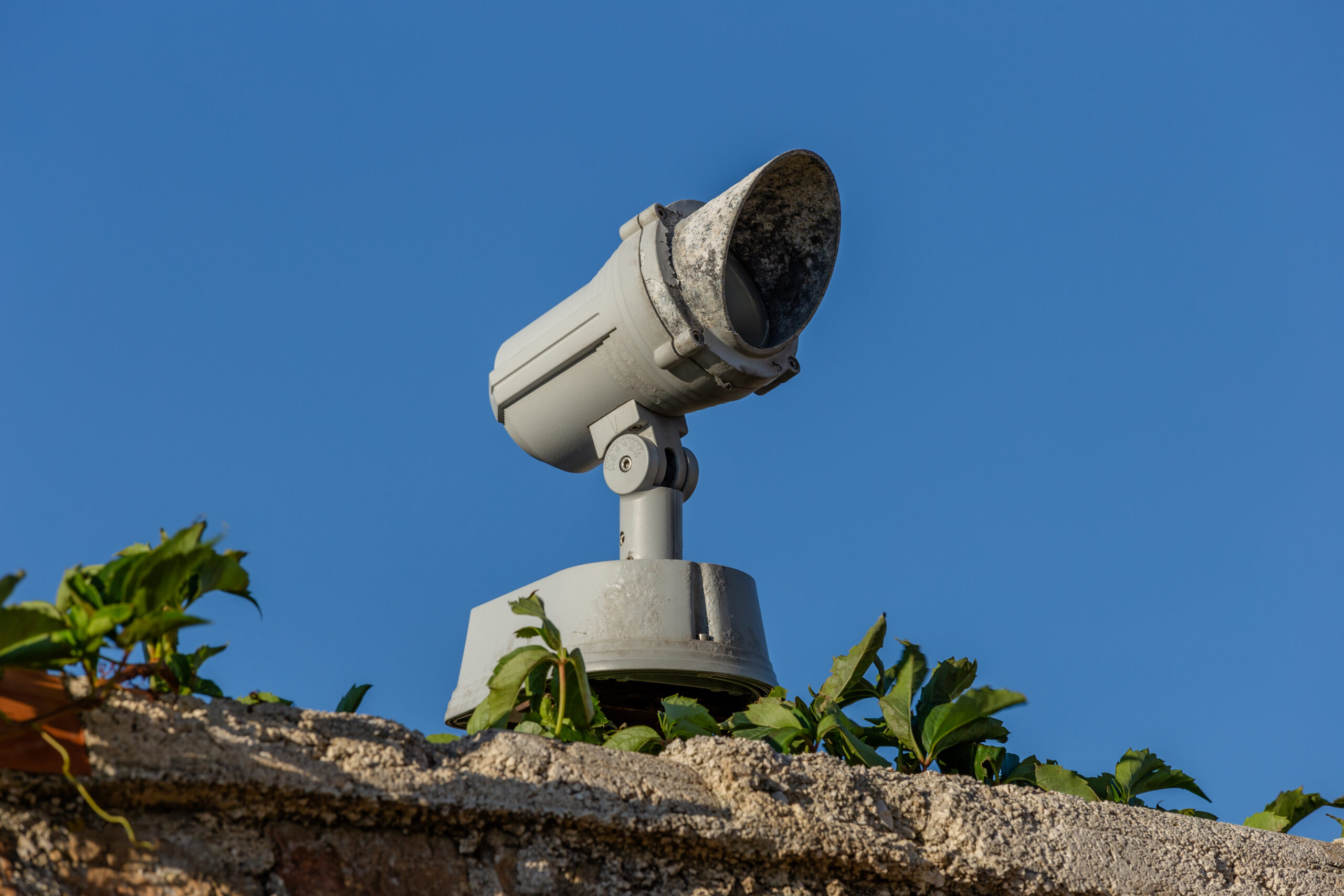 Exterior surveillance camera on a masonry mounting bracket in Piran, Slovenia