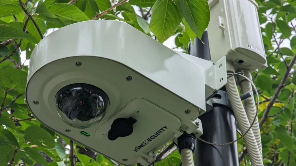 Outdoor dome camera mounted beside a cable junction