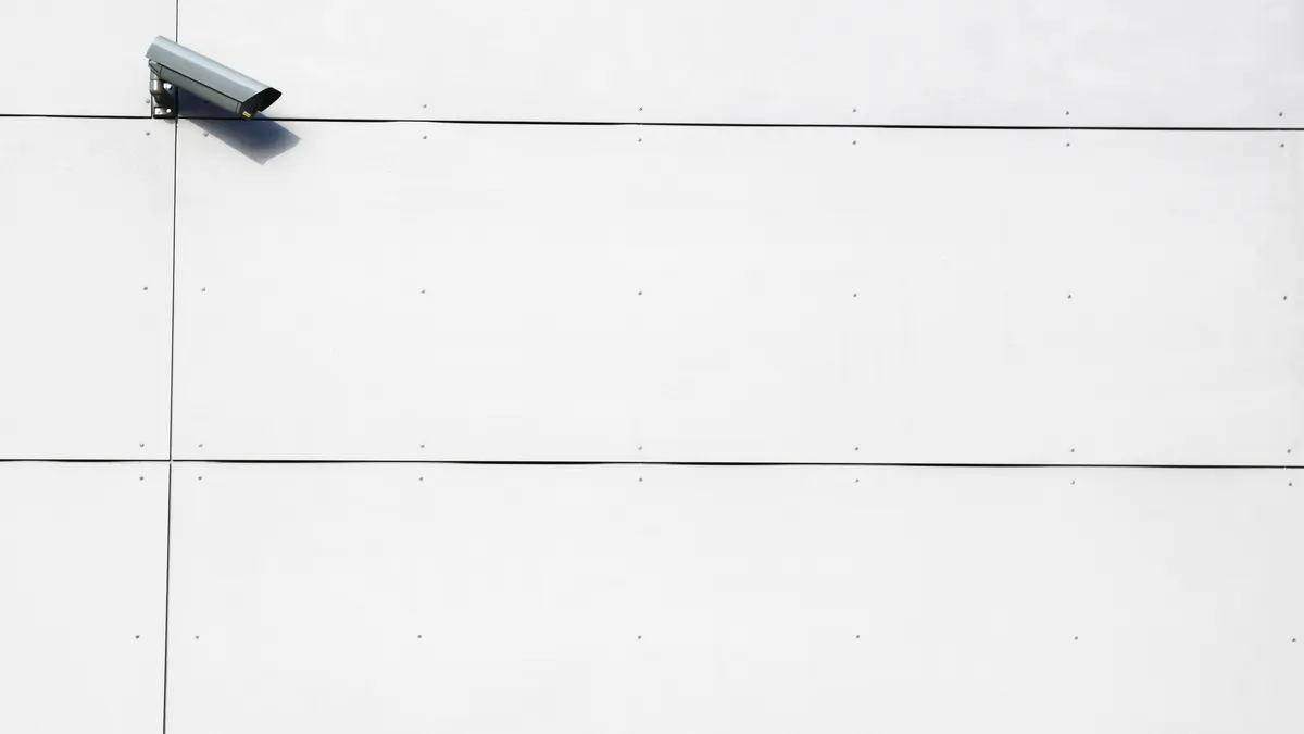 Wall-mounted security camera used to illustrate camera-view changes during privacy-mask checks